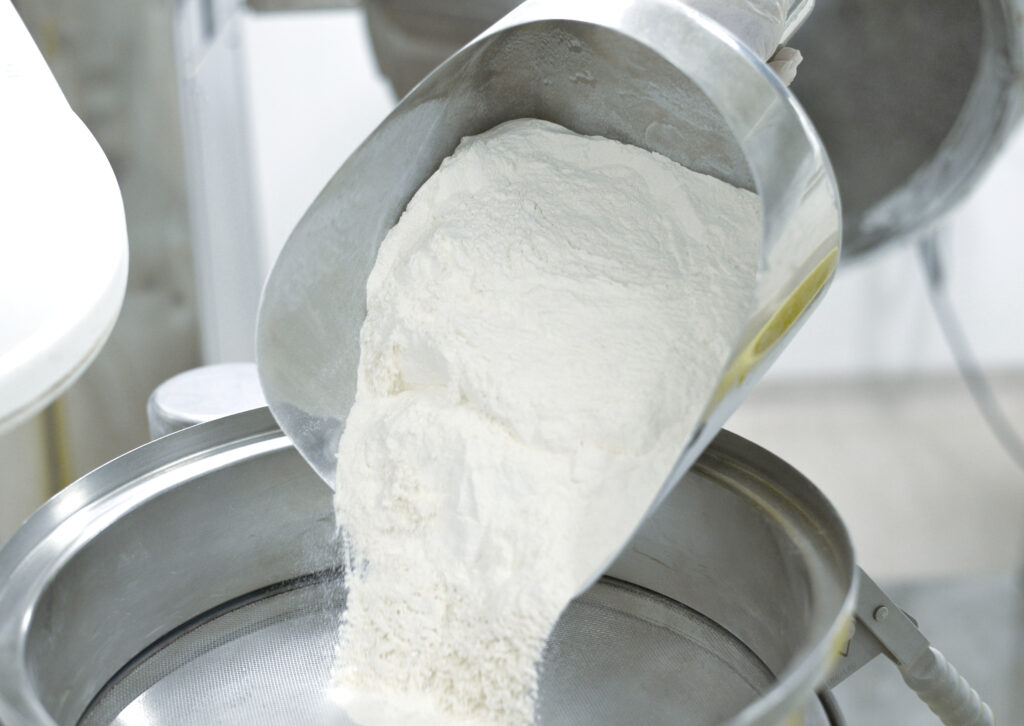 Powder being sieved to remove clumps